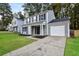 Charming two-story home with a gray exterior, white trim, and attached garage at 1344 Mill Lake Cir, Stone Mountain, GA 30088