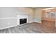 Living room with a white brick fireplace, gray walls, and wood-look flooring at 1344 Mill Lake Cir, Stone Mountain, GA 30088