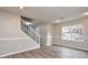 Living room featuring wood-look flooring, a staircase, and large window at 1344 Mill Lake Cir, Stone Mountain, GA 30088