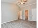 Large main bedroom with wood-look flooring, ceiling fan, and ensuite bathroom access at 1344 Mill Lake Cir, Stone Mountain, GA 30088