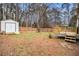 Backyard with deck, shed, and wooden fence at 155 Meadowbrook Dr, Mcdonough, GA 30253