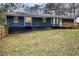 House exterior showcasing a deck and a spacious backyard at 155 Meadowbrook Dr, Mcdonough, GA 30253