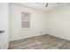Spacious bedroom with wood-look floors and large window at 155 Meadowbrook Dr, Mcdonough, GA 30253