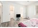 Bright bedroom with wood-look floors, a walk-in closet, and access to the bathroom at 155 Meadowbrook Dr, Mcdonough, GA 30253
