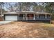 Ranch style home with gray siding, white trim, and a red front door at 155 Meadowbrook Dr, Mcdonough, GA 30253