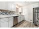 Modern kitchen with white cabinets, stainless steel appliances and gray flooring at 155 Meadowbrook Dr, Mcdonough, GA 30253