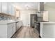 Updated kitchen with white cabinets, stainless steel appliances, and mosaic backsplash at 155 Meadowbrook Dr, Mcdonough, GA 30253