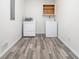 Bright laundry room with washer, dryer, and overhead shelving at 155 Meadowbrook Dr, Mcdonough, GA 30253