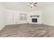 Spacious living room with wood-look floors, a stone fireplace, and a ceiling fan at 155 Meadowbrook Dr, Mcdonough, GA 30253