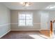 Bright living room with neutral walls, carpet, and a large window at 519 Judith Ct, Mcdonough, GA 30252
