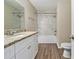 Modern bathroom featuring granite countertops, white cabinets, and a tiled shower at 2329 Wilkins Cv, Decatur, GA 30035