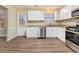 Kitchen boasts white cabinets, granite countertops, and stainless steel appliances at 2329 Wilkins Cv, Decatur, GA 30035