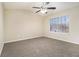 Spacious main bedroom with carpet, ceiling fan, and large window at 2329 Wilkins Cv, Decatur, GA 30035