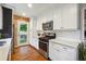 Updated kitchen with white shaker cabinets, stainless steel appliances, and brick accent wall at 3115 Cloverhurst Dr, Atlanta, GA 30344