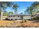 Spacious backyard with mature trees and patio at 1933 Glen Echo Dr, Decatur, GA 30032