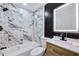 Modern bathroom with marble tile and updated fixtures at 1933 Glen Echo Dr, Decatur, GA 30032