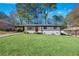 Ranch style home with white brick exterior, red door, and landscaped lawn at 1933 Glen Echo Dr, Decatur, GA 30032