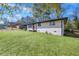 Side view of a ranch home with white brick and a grassy yard at 1933 Glen Echo Dr, Decatur, GA 30032