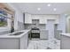 Renovated kitchen, gray cabinets, white countertops, and marble flooring at 1933 Glen Echo Dr, Decatur, GA 30032