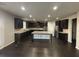 Modern kitchen with dark wood cabinets, an island, and stainless steel appliances at 566 Mariposa Ln, Mcdonough, GA 30253