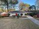 Ranch home with red door, landscaped lawn, and driveway at 2030 Shamrock Dr, Decatur, GA 30032