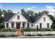 Inviting farmhouse-style home with white siding, a brick walkway, and a white picket fence at 43 Wickford Way, Villa Rica, GA 30180