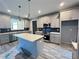 Modern kitchen featuring gray shaker cabinets, quartz countertops, and stainless steel appliances at 43 Wickford Way, Villa Rica, GA 30180