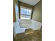 Large soaking tub with built-in steps in a well-lit bathroom at 985 James Ridge Dr, Lawrenceville, GA 30045