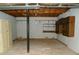 Unfinished basement with built-in shelving and storage cabinets at 10155 Twin Oaks Sw Dr, Covington, GA 30014