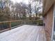 Spacious wooden deck with wire railing and trees in the background at 10155 Twin Oaks Sw Dr, Covington, GA 30014