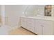 Bright bathroom with double vanity, white cabinets, and tile floors at 1351 Lakeview East Dr, Atlanta, GA 30316