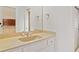 Bathroom vanity with tan countertop, white cabinets, and a mirror at 1351 Lakeview East Dr, Atlanta, GA 30316