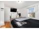 Bedroom with gray upholstered bed, hardwood floors, and a large TV at 24 Daniel Se St # 8, Atlanta, GA 30312