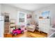 Bedroom with hardwood floors, white furniture, and a pink toy car at 24 Daniel Se St # 8, Atlanta, GA 30312