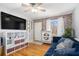 Living room with hardwood floors, a blue couch, and a large TV at 24 Daniel Se St # 8, Atlanta, GA 30312