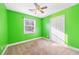 Bright bedroom with green walls, neutral carpet, and ample closet space at 1035 Stonewall Se Dr, Atlanta, GA 30315