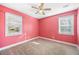 Charming bedroom with pink walls, neutral carpet and two windows at 1035 Stonewall Se Dr, Atlanta, GA 30315