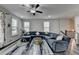 Gathering room with sectional sofa, hardwood floors, and ceiling fan at 4215 Essex Pond Way, Cumming, GA 30040