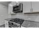 Stainless steel appliances and granite countertops in this modern kitchen at 4215 Essex Pond Way, Cumming, GA 30040