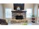 Stone fireplace with TV and windows bringing in natural lighting at 7460 Highway 101 N, Rockmart, GA 30153