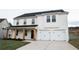 Inviting two-story home featuring white brick, wooden accents, and a welcoming front porch at 333 Orwell Dr, Social Circle, GA 30025