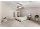 Spacious bedroom with plush carpet, a comfortable bed, and stylish seating area at 2635 General Lee Way, Buford, GA 30519