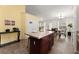 Kitchen island with ample counter space, dark wood cabinets, and view to the dining area at 2635 General Lee Way, Buford, GA 30519