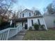 Two-story house with gray siding, a small porch, and a white picket fence at 70 Gardenia Nw Dr, Atlanta, GA 30314