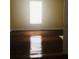 Shiny hardwood floors and a large window brighten this bedroom at 309 Fletcher Sw St, Atlanta, GA 30315