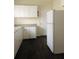 Bright kitchen with white cabinets, dark floors, and a white refrigerator at 309 Fletcher Sw St, Atlanta, GA 30315