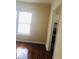 Spacious living room with polished hardwood floors and doorway to the kitchen at 309 Fletcher Sw St, Atlanta, GA 30315