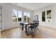 Dining room with modern table and chairs, hardwood floors, and large windows at 105 Channing Ln, Fayetteville, GA 30214