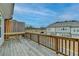 Wooden deck with wooden railing overlooking other townhomes at 2689 Richmond Row, Suwanee, GA 30024