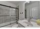Guest bathroom with tiled shower and modern fixtures at 2689 Richmond Row, Suwanee, GA 30024